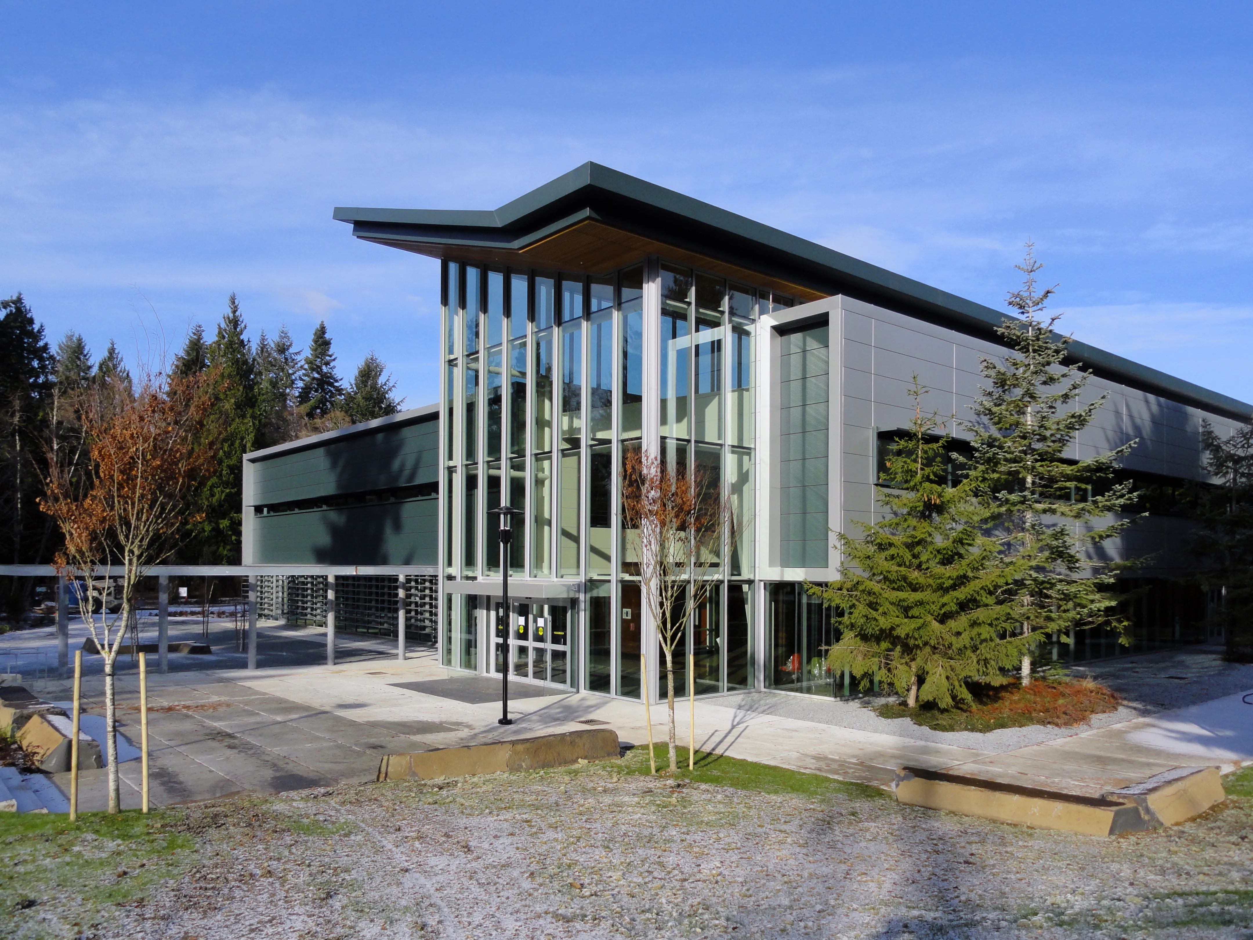 Photo taken from the exterior south side of the building featuring the existing steel framing of the old sky-bridge.