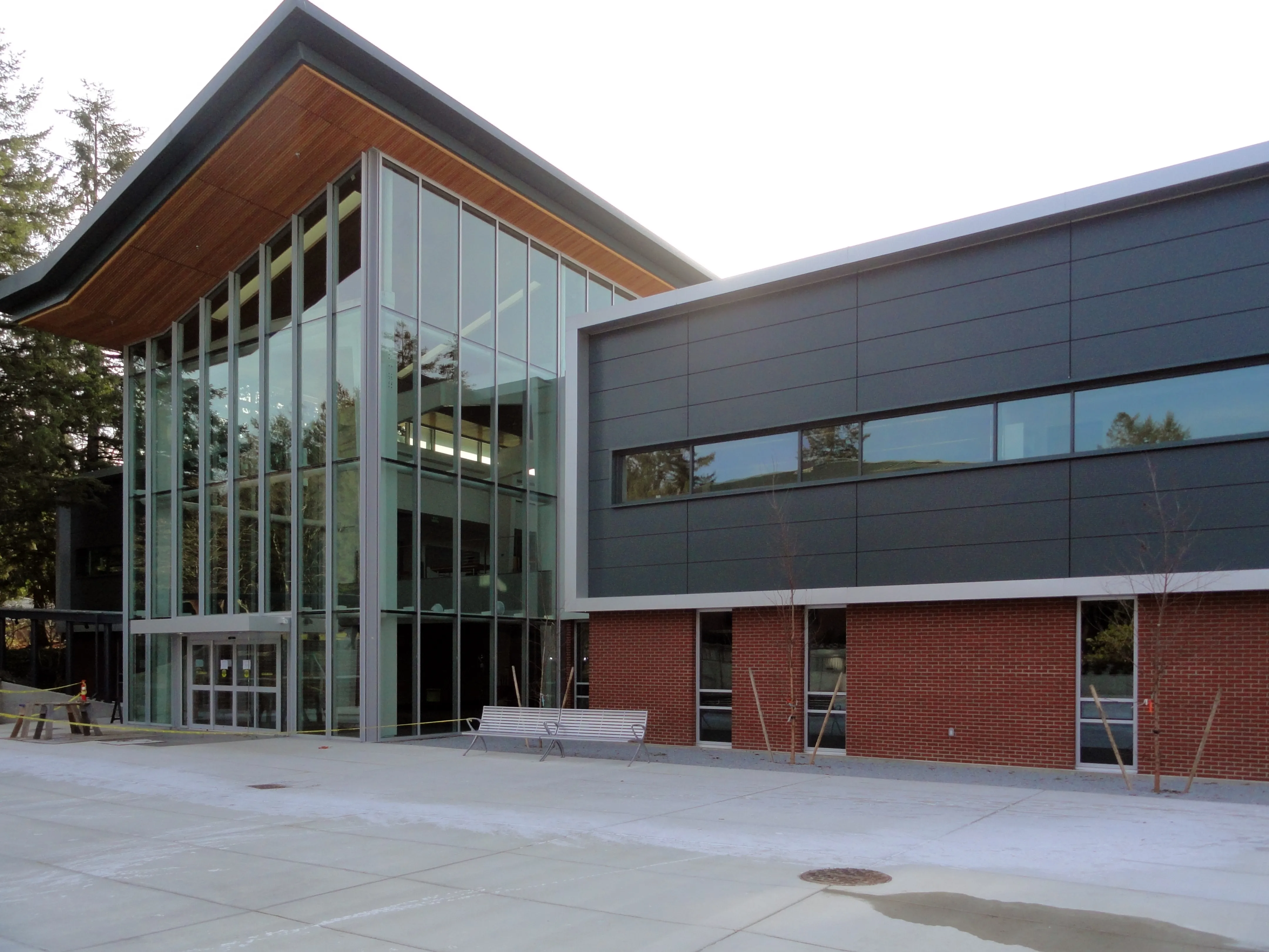 Photo of the North entrance taken from outside featuring the floor-to-roof glass curtain-walls.