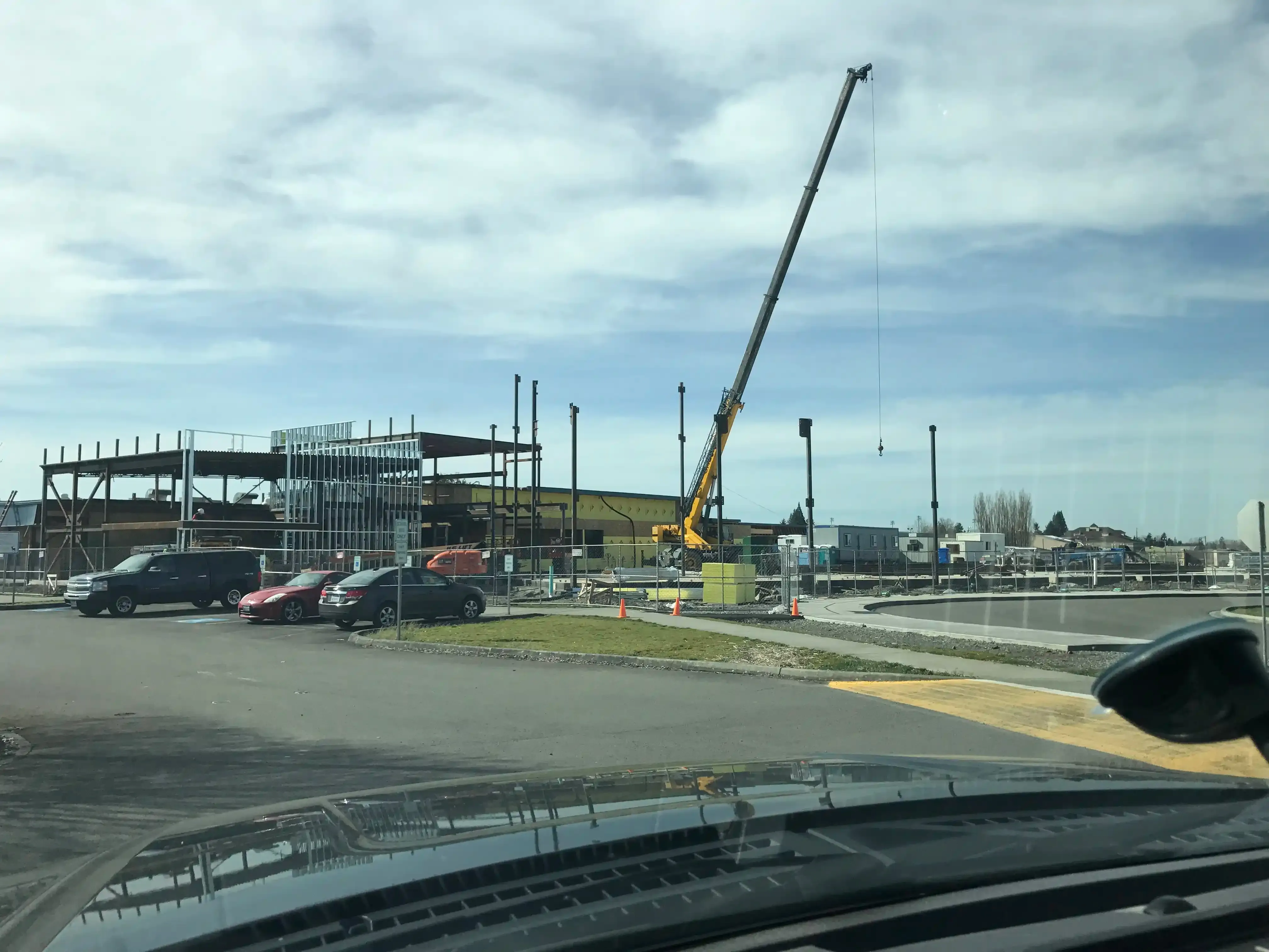 Photo taken from NE of site featuring a large crane in the process of erecting the steel structure of the building. Photo taken from NE of site featuring a large crane in the process of erecting the steel structure of the building.