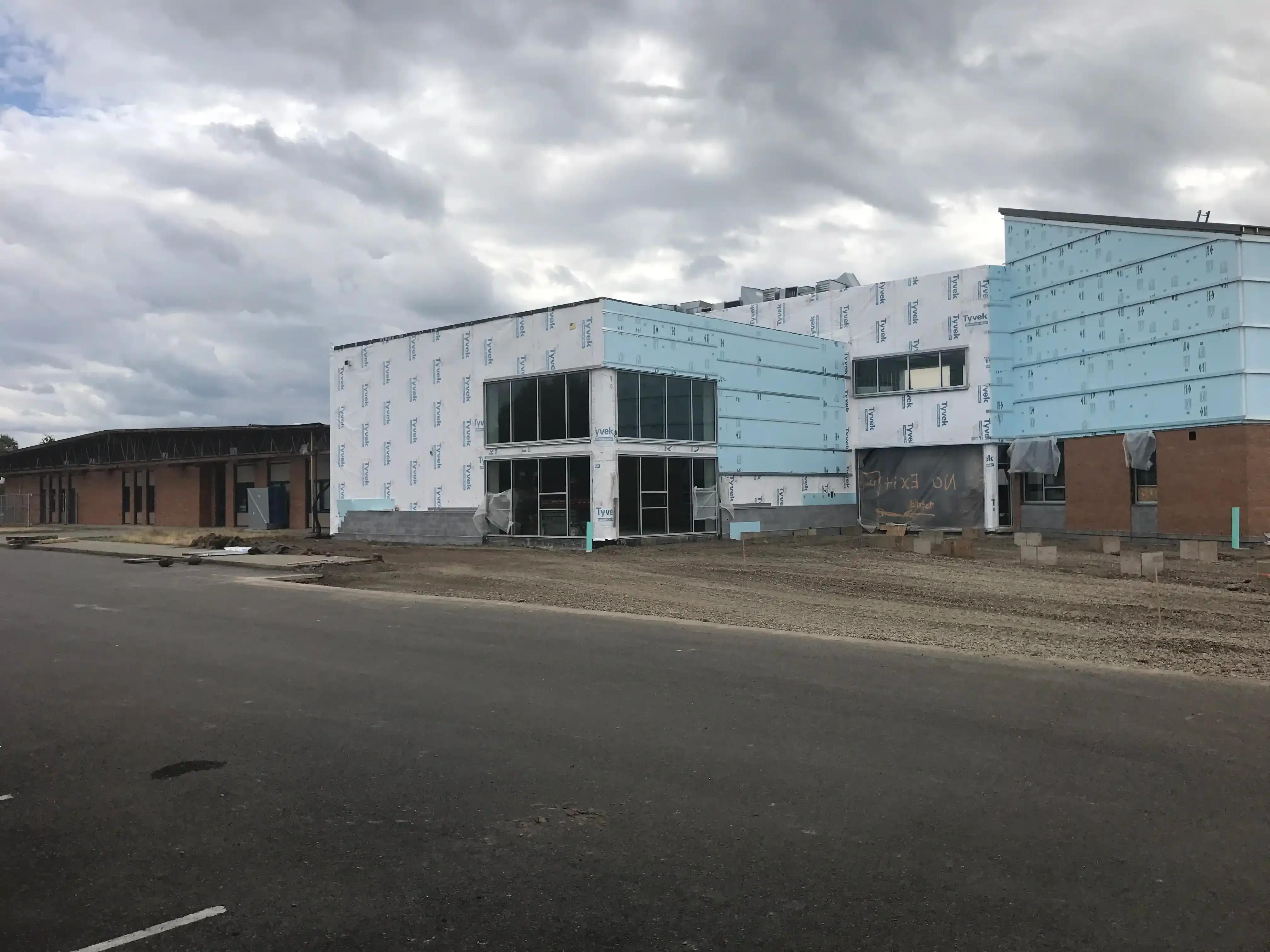 Photo showing a bubble level held up to the edge of brick veneer in which the original masonry is not plumb. Photo showing a bubble level held up to the edge of brick veneer in which the original masonry is not plumb.