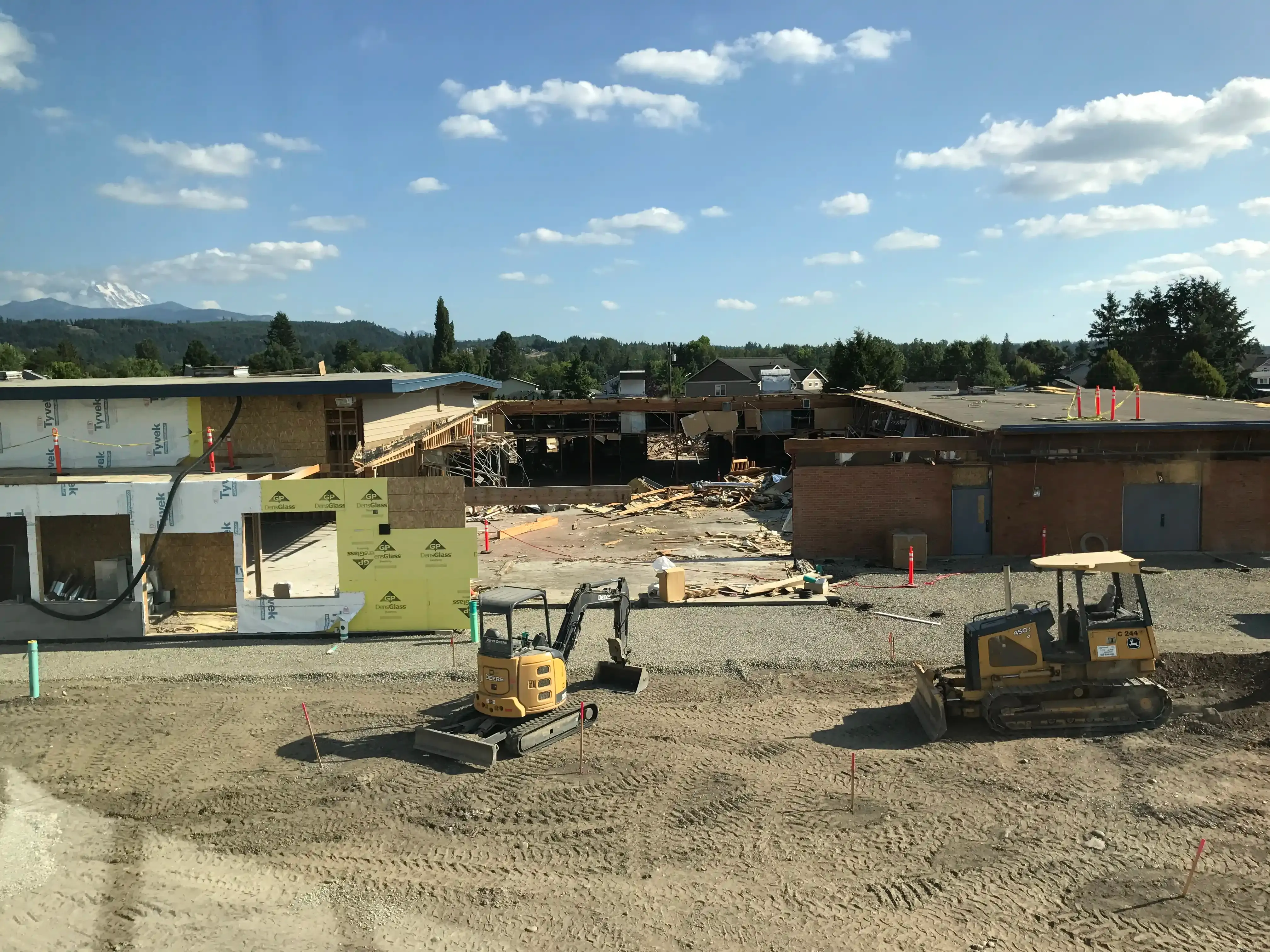 Photo of the existing school with a portion in the middle completely removed to the ground. Photo of the existing school with a portion in the middle completely removed to the ground.