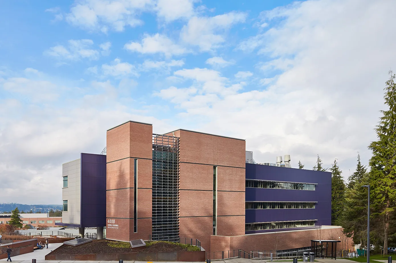 Photo taken from the Northwest direction of the outside of the building showcasing extensive brick veneer and 4 stories of exterior sunshades.