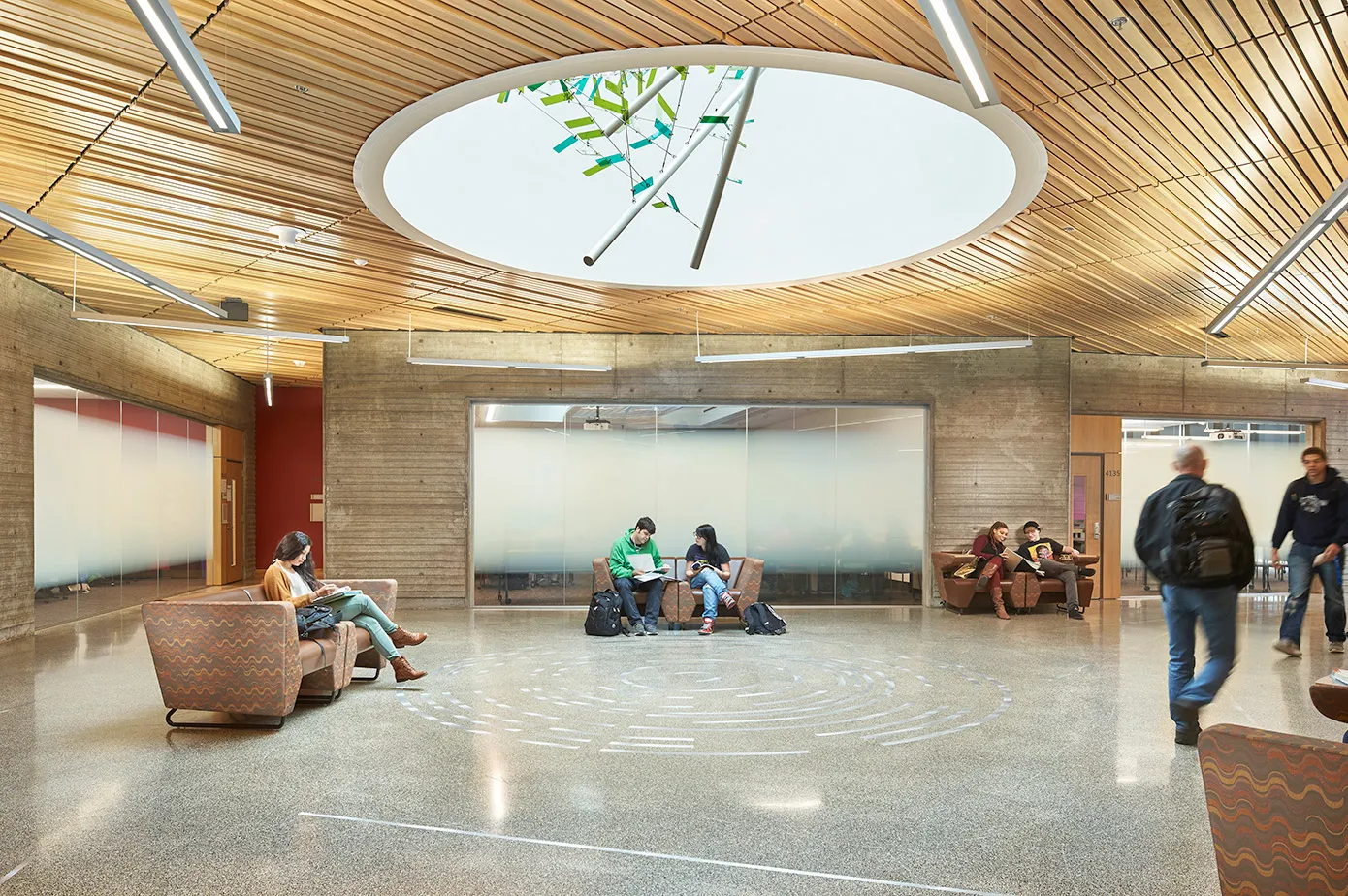 Photo of an art installation hanging from above within the skylight and metal inlays cast into the terrazo floor below.