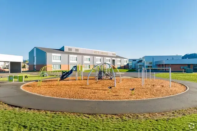 Photo of the new play structure with the school in the background. Photo of the new play structure with the school in the background.