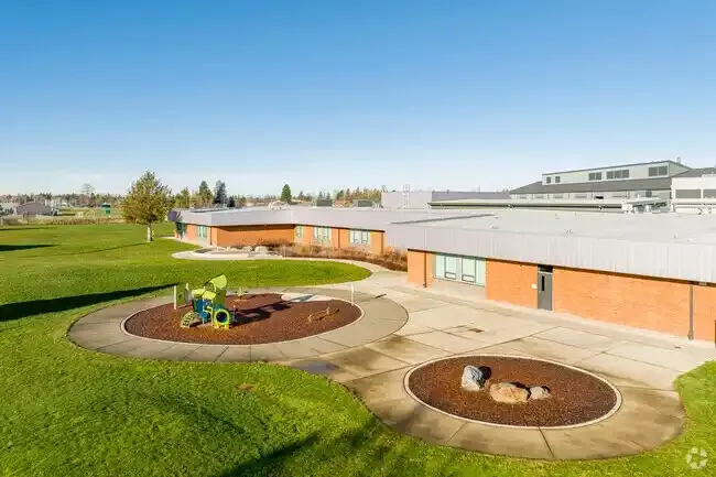 Photo of the new play structure with the school in the background. Photo of the new play structure with the school in the background.
