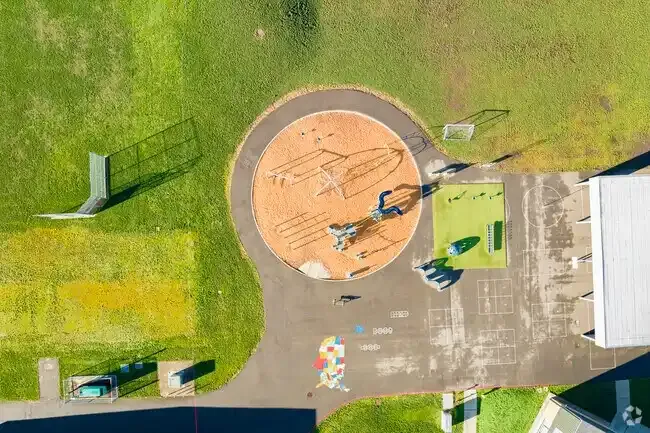Photo of the new play structure with the school in the background. Photo of the new play structure with the school in the background.