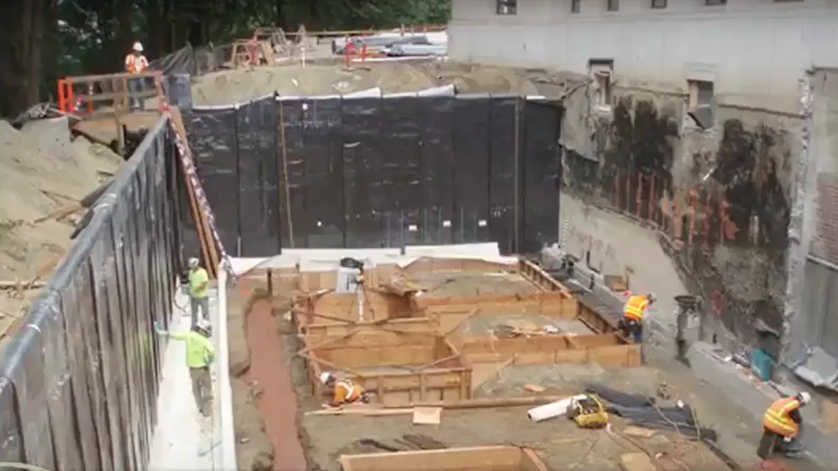 Mass excavationi behind the John L O'Brien building with shoring in place and some new footing forms.