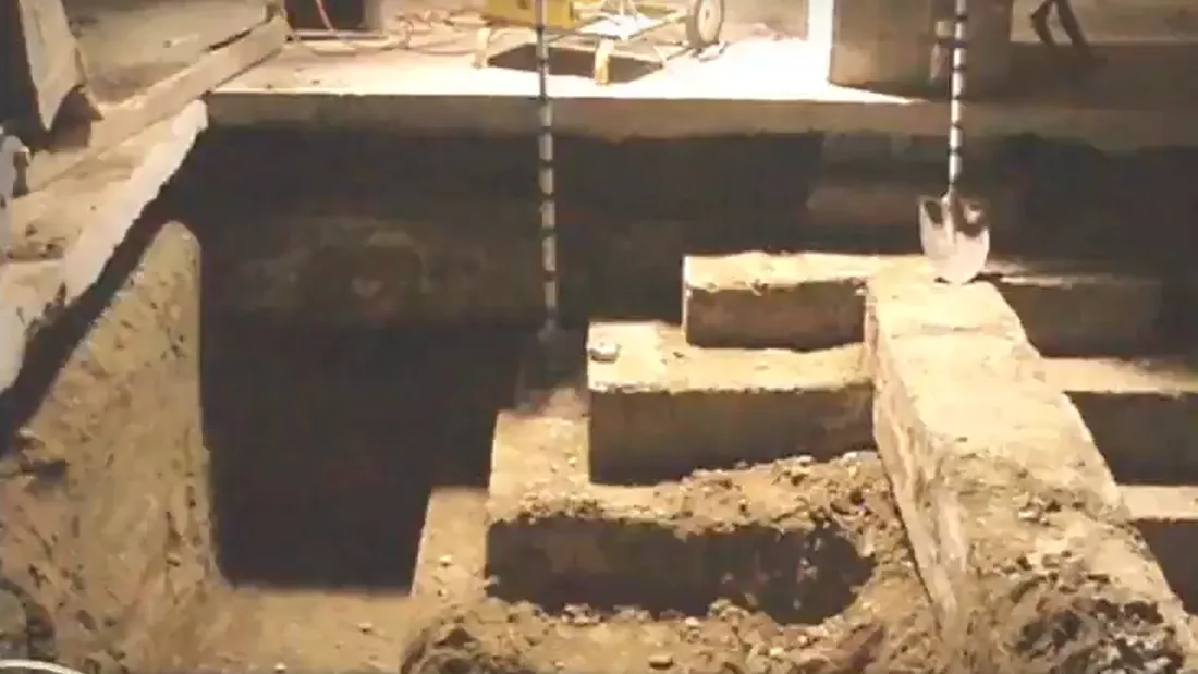 Photo of exposed concrete foundations, below floor level.