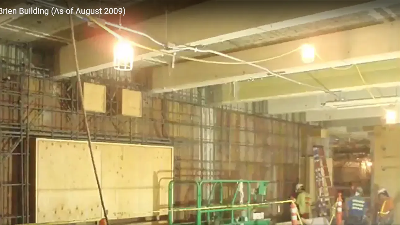 Photo of a large wall of rebar with workers and equipment in front.